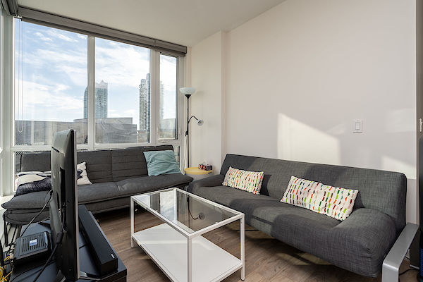 Living+room+with+floor+to+ceiling+windows+offering+plenty+of+natural+light+and+views+over+the+East+Village+and+the+Bell+Center Calgary 1 bedroom Condo Unit for rent. Property photo: 314156-2