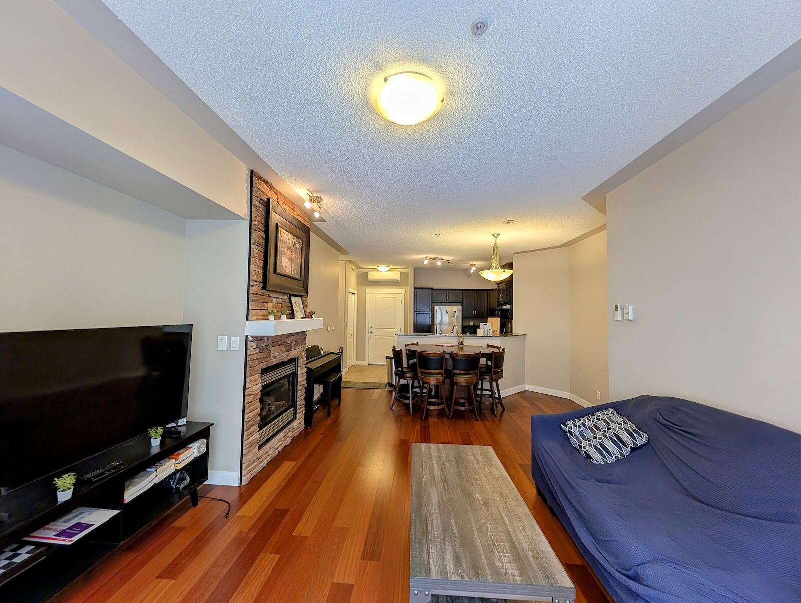 Cozy+living+room+with+fireplace+and+wooden+floor Calgary 2 + Den bedrooms Condo Unit for rent. Property photo: 606379-1