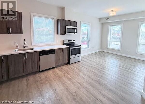 Kitchen+featuring+light+countertops+dark+brown+cabinets+light+wood-style+floors+stainless+steel+appliances+and+a+sink Hamilton 2 bedrooms Apartment for rent. Property photo: 623891-2