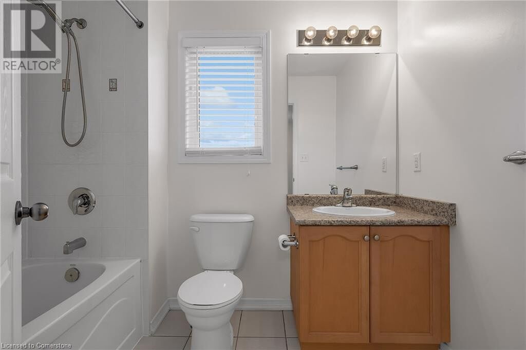 Bathroom+with+vanity+baseboards+tile+patterned+flooring+toilet+and+shower+bathing+tub+combination Hamilton 3 bedrooms House for rent. Property photo: 625136-1