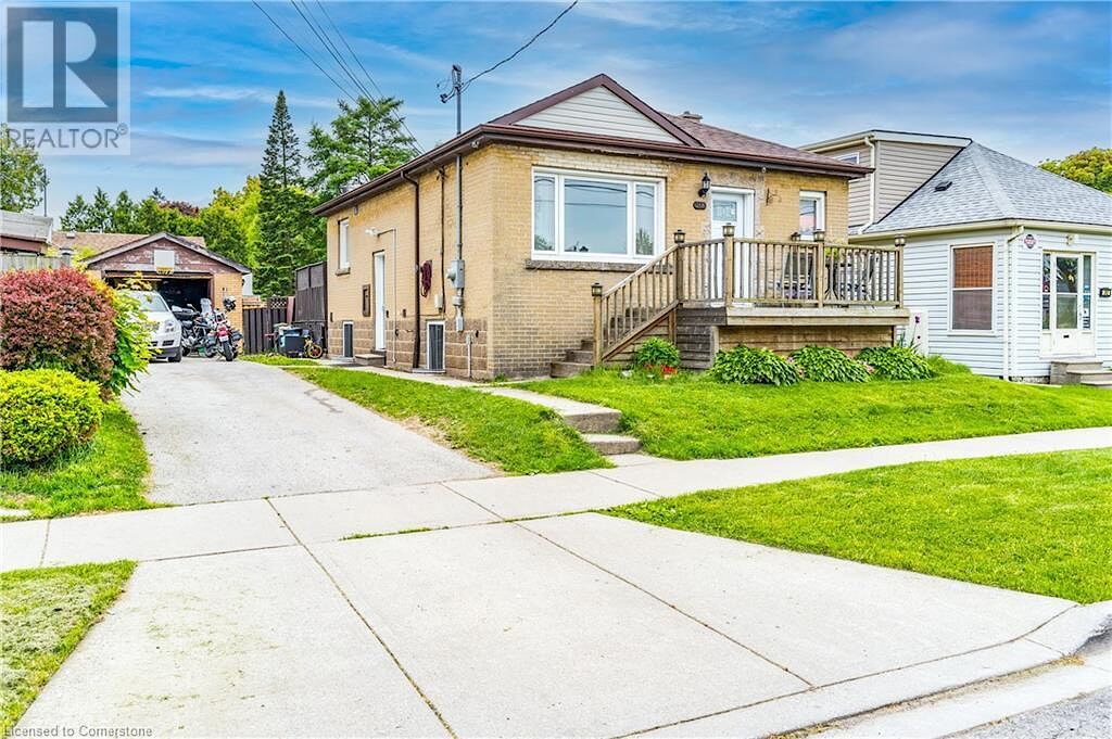 View+of+front+of+property+with+a+front+lawn+brick+siding+a+garage+and+an+outdoor+structure Hamilton 2 bedrooms House for rent. Property photo: 637755-1